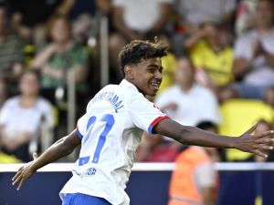 Barcelona's Spanish forward #27 Lamine Yamal celebrates after Barcelona's Polish forward #09 Robert Lewandowski (not seen) scored during the Spanish Liga football match between Villarreal CF and FC Barcelona at La Ceramica stadium in Vila-real on August 27, 2023. (Photo by JAVIER SORIANO / AFP)