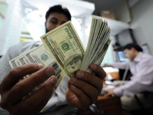 A Pakistani money dealer counts US dollars notes at a money market in Islamabad. AFP US Dollars Big Win Ticket