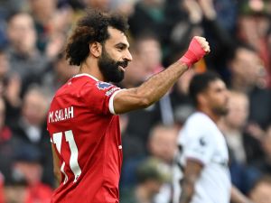 Liverpool's Egyptian striker #11 Mohamed Salah celebrates after scoring the opening goal from the penalty spot during the English Premier League football match between Liverpool and West Ham United at Anfield in Liverpool, north west England on September 24, 2023. (Photo by Paul ELLIS / AFP)