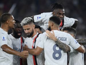AC Milan's French forward #09 (3rd L) Olivier Giroud celebrates with teammates after scoring his team's first goal during the Italian Serie A football match between AS Roma and AC Milan at the Olympic stadium in Rome on September 1, 2023. (Photo by Filippo MONTEFORTE / AFP)