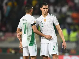Algeria's forward Riyad Mahrez (L) and Algeria's defender Aissa Mandi (R) react after Ivory Coast won the Group E Africa Cup of Nations (CAN) 2021 football match between Ivory Coast and Algeria at Stade de Japoma in Douala on January 20, 2022. (Photo by CHARLY TRIBALLEAU / AFP)