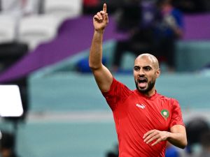 Morocco's midfielder #04 Sofyan Amrabat warms up ahead of the Qatar 2022 World Cup semi-final football match between France and Morocco at the Al-Bayt Stadium in Al Khor, north of Doha on December 14, 2022. (Photo by GABRIEL BOUYS / AFP)