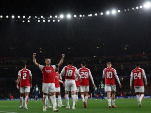 Arsenal's Norwegian midfielder #08 Martin Odegaard celebrates scoring the team's fourth goal during the UEFA Champions League Group B football match between Arsenal and PSV Eindhoven at the Arsenal Stadium in north London on September 20, 2023. (Photo by Adrian DENNIS / AFP)