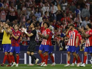Atletico Madrid players celebrate their win at the end of the Spanish Liga football match between Club Atletico de Madrid and Real Madrid CF at the Metropolitano stadium in Madrid on September 24, 2023. (Photo by OSCAR DEL POZO / AFP)