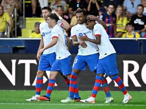 (From L) Barcelona's Polish forward #09 Robert Lewandowski celebrates with Barcelona's Spanish midfielder #06 Gavi, Barcelona's French defender #23 Jules Kounde and Barcelona's Spanish forward #27 Lamine Yamal scoring his team's fourth goal during the Spanish Liga football match between Villarreal CF and FC Barcelona at La Ceramica stadium in Vila-real on August 27, 2023. (Photo by JAVIER SORIANO / AFP)