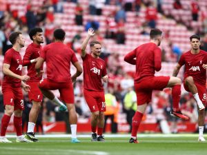 Liverpool's Argentinian midfielder #10 Alexis Mac Allister (C) warms up ahead of the English Premier League football match between Liverpool and Bournemouth at Anfield in Liverpool, north west England on August 19, 2023. (Photo by Darren Staples / AFP)