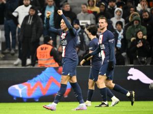 Paris Saint-Germain's French forward Kylian Mbappe celebrates after scoring his team's third goal during the French L1 football match between Olympique Marseille (OM) and Paris Saint-Germain (PSG) at the Velodrome stadium in Marseille, southern France on February 26, 2023. (Photo by CHRISTOPHE SIMON / AFP)