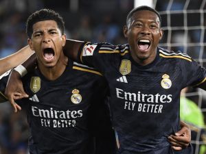 Real Madrid's English midfielder #5 Jude Bellingham (L) celebrates his goal with Real Madrid's Austrian defender #04 David Alaba during the Spanish Liga football match between RC Celta de Vigo and Real Madrid CF at the Balaidos stadium in Vigo on August 25, 2023. (Photo by MIGUEL RIOPA / AFP)