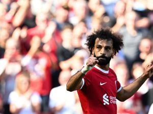 Liverpool's Egyptian striker #11 Mohamed Salah celebrates after scoring his team third goal during the English Premier League football match between Liverpool and Aston Villa at Anfield in Liverpool, north-west England on September 3, 2023. (Photo by Paul ELLIS / AFP)