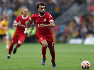 Liverpool's Egyptian striker #11 Mohamed Salah runs with the ball during the English Premier League football match between Wolverhampton Wanderers and Liverpool at the Molineux stadium in Wolverhampton, central England on September 16, 2023. (Photo by Adrian DENNIS / AFP)