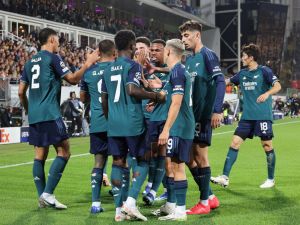 Arsenal's players celebrate after scoring the opening goal during the UEFA Champions League Group B first leg football match between RC Lens and Arsenal FC at the Bollaert Stadium in Lens, northern France, on October 3, 2023. (Photo by DENIS CHARLET / AFP)