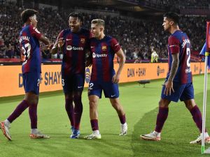 Barcelona's Spanish forward #27 Lamine Yamal and teammates celebrate Sevilla's Spanish defender #04 Sergio Ramos' owngoal during the Spanish Liga football match between FC Barcelona and Sevilla FC at the Estadi Olimpic Lluis Companys in Barcelona on September 29, 2023. (Photo by Pau BARRENA / AFP)
