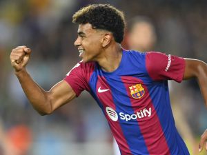 Barcelona's Spanish forward #27 Lamine Yamal celebrates Sevilla's Spanish defender Sergio Ramos' owngoal during the Spanish Liga football match between FC Barcelona and Sevilla FC at the Estadi Olimpic Lluis Companys in Barcelona on September 29, 2023. (Photo by Pau BARRENA / AFP)
