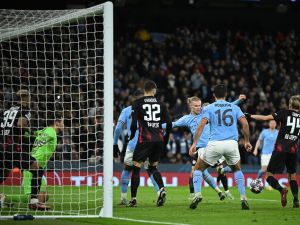 Manchester City's Norwegian striker Erling Haaland (4R) scores the team's fifth goal, his fourth, during the UEFA Champions League round of 16 second-leg football match between Manchester City and RB Leipzig at the Etihad Stadium in Manchester, north west England, on March 14, 2023. (Photo by Oli SCARFF / AFP)