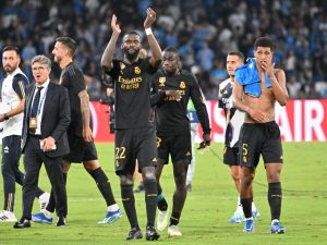 Real Madrid's German defender #22 Antonio Rudiger and Real Madrid's English midfielder #5 Jude Bellingham celebrate at the end of the UEFA Champions League 1st round day 2 Group C football match Napoli vs Real Madrid at the Diego Armando Maradona stadium in Naples on October 3, 2023. (Photo by Alberto PIZZOLI / AFP)
