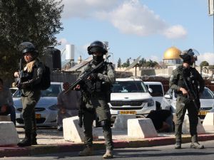 Israeli occupation forces stand guard as Palestinians take part in Friday