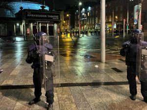 Irish Garda riot police form a cordon at the junction of Parnell Street and O'Connell Street Upper, after a police car was set on fire in Dublin. (Peter Murphy/ AFP)