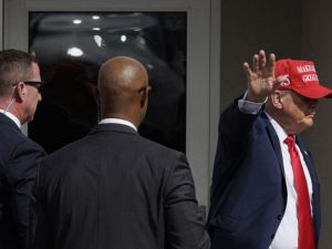 Former President Donald Trump waves to the crowd after giving remarks at the South Texas International airport on November 19, 2023 in Edinburg, Texas. (Michael Gonzalez/ AFP)