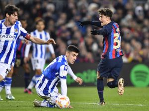 Barcelona's Spanish midfielder Gavi (R) reacts during the Copa del Rey (King's Cup), quarter final football match between FC Barcelona and Real Sociedad, at the Camp Nou stadium in Barcelona on January 25, 2023. (Photo by Pau BARRENA / AFP)