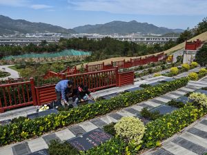 Seakoo Wu and his wife visiting the grave of their son Wu Xuanmo, who died last year aged 22 while attending Exeter University in Britain, at a cemetery in China's eastern Zhejiang province. (Photo by Hector RETAMAL / AFP) artificial intelligence