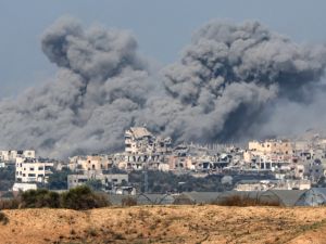 A picture taken from southern Israel near the border with the Gaza Strip on December 6, 2023, shows smoke billowing during Israeli bombardment in Gaza amid continuing battles between Israel and Hamas. (Jack Guez/ AFP)