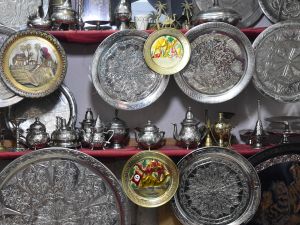 Engraved plates are displayed at a shop in the souks of the medina of Tunis. (Photo by FETHI BELAID / AFP) metal engraving