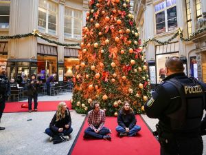 Climate activists spray Christmas trees with orange paint in Germany. (Jan Woitas/ X)