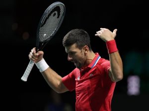 Serbia's Novak Djokovic reacts during the men's doubles semifinal tennis match between Italy and Serbia of the Davis Cup tennis tournament at the Martin Carpena sportshall, in Malaga on November 25, 2023. (Photo by LLUIS GENE / AFP)