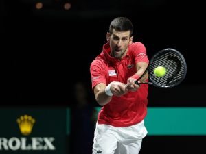 Serbia's Novak Djokovic returns the ball against Italy's Jannik Sinner during the second men's singles semifinal tennis match between Italy and Serbia of the Davis Cup tennis tournament at the Martin Carpena sportshall, in Malaga on November 25, 2023. (Photo by LLUIS GENE / AFP)