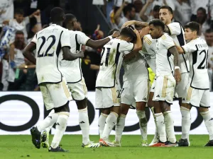 Real Madrid players celebrate English midfielder #5 Jude Bellingham's goal during the UEFA Champions League 1st round day 1 group C football match between Real Madrid and Union Berlin at the Santiago Bernabeu stadium in Madrid on September 20, 2023. (Photo by OSCAR DEL POZO / AFP)