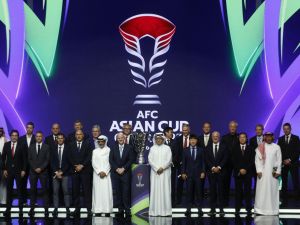 FIFA President Gianni Infantino (C-L) and President of the Asian Football Confederation (AFC) Sheikh Salman bin Ibrahim al-Khalifa (C-R) pose for a picture with the trophy and coaches during the draw for the AFC Asian Cup in Doha on May 11, 2023. (Photo by KARIM JAAFAR / AFP)