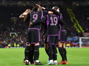 Bayern Munich's players celebrate the opening goal scored by Bayern Munich's French forward #11 Kingsley Coman during the UEFA Champions League group A football match between Manchester United and FC Bayern Munich at Old Trafford stadium in Manchester, north west England, on December 12, 2023. (Photo by PETER POWELL / AFP)