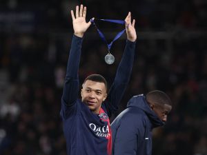 Paris Saint-Germain's French forward #07 Kylian Mbappe celebrates with his medal after winning the French Champions' Trophy (Trophee des Champions) football match between Paris Saint-Germain (PSG) and Toulouse FC at the Parc des Princes stadium in Paris on January 3, 2024. (Photo by FRANCK FIFE / AFP)