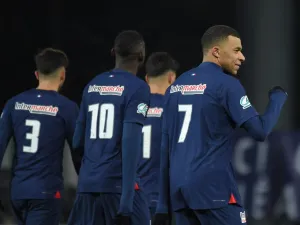 Paris Saint-Germain's French forward #07 Kylian Mbappe (R) reacts after scoring his team's second goal during the French Cup round of 32 football match between US Orleans Loiret Football and Paris Saint-Germain (PSG) at the Stade de la Source, in Orleans, central France, on January 20, 2024. (Photo by Guillaume SOUVANT / AFP)