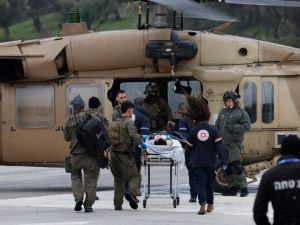 An Israeli medical team transports a peson wounded in a rocket attack fired from southern Lebanon at Ziv hospital in Israel's northern city of Safed on February 14, 2024. AFP