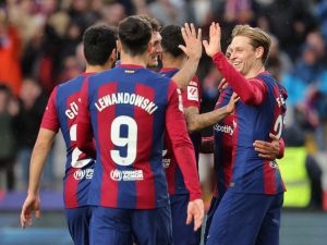 Barcelona's Dutch midfielder #21 Frenkie de Jong (R) celebrates with teammates scoring his team's third goal with teammates during the Spanish league football match between FC Barcelona and Getafe CF at the Estadi Olimpic Lluis Companys in Barcelona on February 24, 2024. (Photo by LLUIS GENE / AFP)