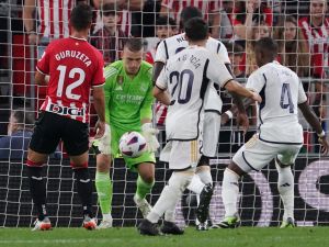 Real Madrid's Ukrainian goalkeeper #13 Andriy Lunin stops the ball during the Spanish Liga football match between Athletic Bilbao and Real Madrid at the San Mames stadium in Bilbao on August 12, 2023. (Photo by CESAR MANSO / AFP)