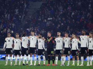 Germany's players observe a minute's silence for former German International players Franz Beckenbauer and Andreas Brehme, ahead of the friendly football match between France and Germany, at the Groupama Stadium in Decines-Charpieu, near Lyon, on March 23, 2024. (Photo by FRANCK FIFE / AFP)