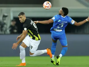 Hilal's Saudi defender #05 Ali al-Bulaihi and Ittihad's Moroccan forward #99 Abderrazak Hamdallah vie for the ball during the Saudi Pro League football match between Al-Ittihad and Al-Hilal at Prince Abdullah al-Faisal Stadium in Jeddah on September 1, 2023. (Photo by AFP)