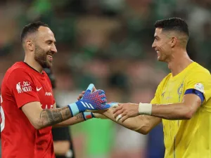 Nassr's Portuguese forward #07 Cristiano Ronaldo celebrates with Nassr's Colombian goalkeeper #26 David Ospina after the Saudi Pro League football match between Al-Ahli and Al-Nassr at the King Abdullah Sport City Stadium in Jeddah on March 15, 2024. (Photo by AFP)