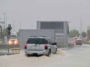 Vehicles drive on a flooded road during torrential rain in the Gulf Emirate of Dubai on April 16, 2024. Torrential rains and high winds lashed parts of the Gulf on April 16, as the death toll from storms in Oman rose to 18, many of them children. (Photo by Giuseppe CACACE / AFP) UAE