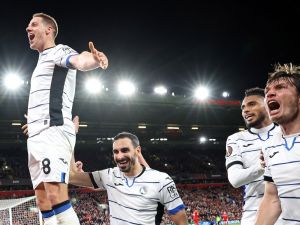 Atalanta's Croatian midfielder #08 Mario Pasalic (L) celebrates scoring the team's third goal during the UEFA Europa League quarter-final first leg football match between Liverpool and Atalanta at Anfield in Liverpool, north west England on April 11, 2024. (Photo by DARREN STAPLES / AFP)