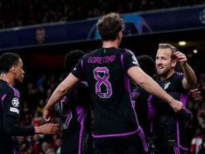Bayern Munich's English striker #09 Harry Kane (R) celebrates with teammates after scoring his team second goal during the UEFA Champions League quarter final first-leg football match between Arsenal and Bayern Munich at the Arsenal Stadium, in north London, on April 9, 2024. (Photo by Ian Kington / IKIMAGES / AFP)
