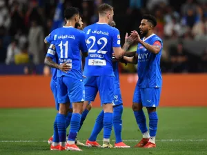 Hilal's Saudi midfielder #29 Salem al-Dawsari celebrates with teammates after scoring his team's second goal during the Saudi Super Cup final football match between Al-Ittihad and Al-Hilal at the Mohammed bin Zayed Stadium in Abu Dhabi on April 11, 2024. (Photo by Ryan LIM / AFP)