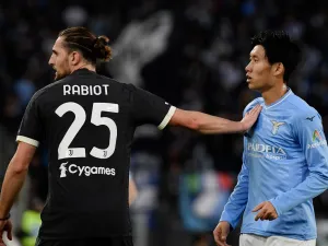 Juventus' French midfielder #25 Adrien Rabiot pushes Lazio's Japanese midfielder #06 Daichi Kamada during the Italian Serie A football match between Lazio and Juventus at the Olympic stadium in Rome, on March 30, 2024. (Photo by Filippo MONTEFORTE / AFP)