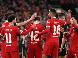 Liverpool's English midfielder #42 Bobby Clark (C) is mobbed by teammates after scoring the team's second goal during the UEFA Europa League round of 16 second leg football match between Liverpool and AC Sparta Praha at Anfield in Liverpool, north west England on March 14, 2024. (Photo by Oli SCARFF / AFP)