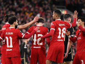 Liverpool's English midfielder #42 Bobby Clark (C) is mobbed by teammates after scoring the team's second goal during the UEFA Europa League round of 16 second leg football match between Liverpool and AC Sparta Praha at Anfield in Liverpool, north west England on March 14, 2024. (Photo by Oli SCARFF / AFP)