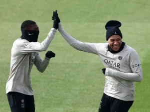 Paris Saint-Germain's French forward #10 Ousmane Dembele (L) reacts with Paris Saint-Germain's French forward #07 Kylian Mbappe during a training session in Poissy, west of Paris, on April 9, 2024, on the eve of their UEFA champions league quarter-final first leg football match against Barcelona. (Photo by FRANCK FIFE / AFP)