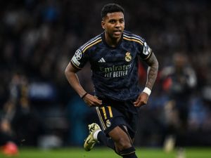 Real Madrid's Brazilian forward #11 Rodrygo celebrates after scoring his team first goal during the UEFA Champions League quarter-final second-leg football match between Manchester City and Real Madrid, at the Etihad Stadium, in Manchester, north-west England, on April 17, 2024. (Photo by Paul ELLIS / AFP)