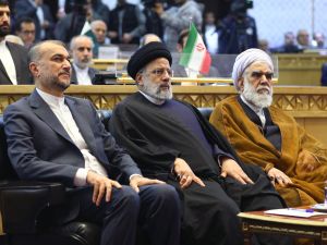 Iranian President Ebrahim Raisi (C), Foreign Minister Iran's Foreign Minister Hossein Amir-Abdollahian (L) and Head of Iran's Judiciary Gholam hossein Mohseni-Ejei attend the Tehran International Conference.  (Photo by Iranian Presidency / AFP) Iran